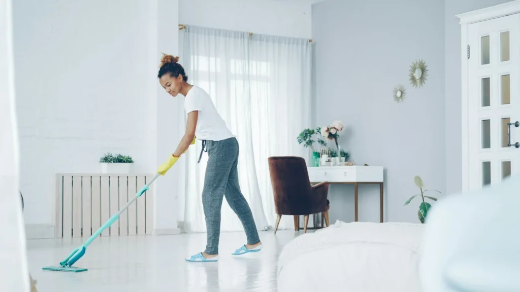 Mopping the floor of a bright living room