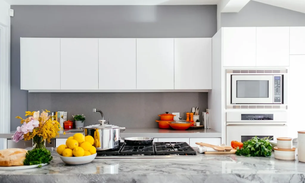 Spotless white kitchen with a marble island